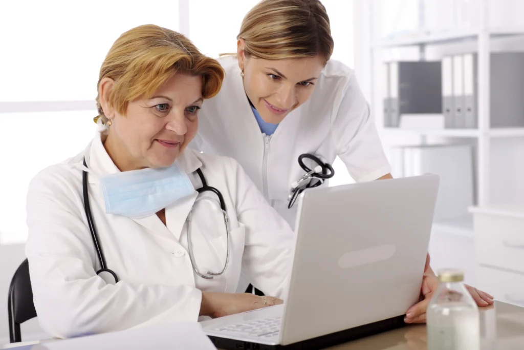 Health care workers looking at a computer