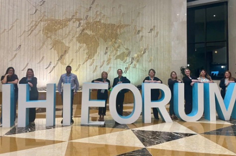 Photo of KHA Quality Team in front of IHI FORUM sign