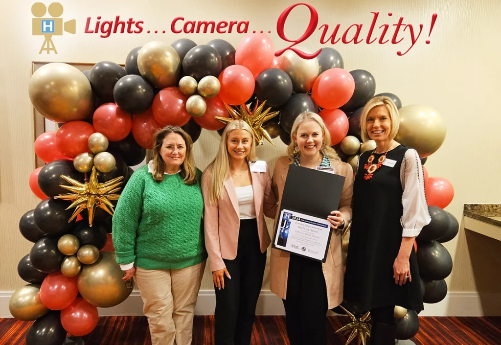 Melanie Landrum presents the KHA 2024 Quality Poster Presentation Award to 3rd Place winner